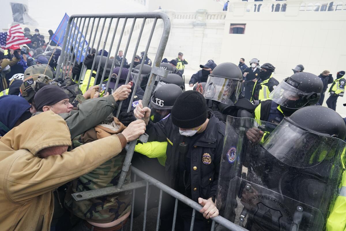 Police try to hold back protesters who gather storm the Capitol on Jan. 6, 2021 in Washington, DC.