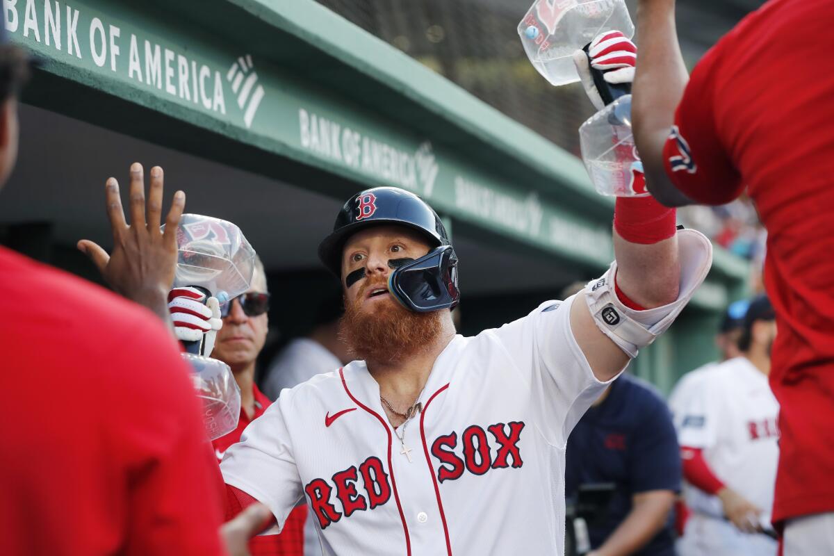 Boston's Justin Turner celebrates after hitting a solo home run in the fourth inning Saturday.