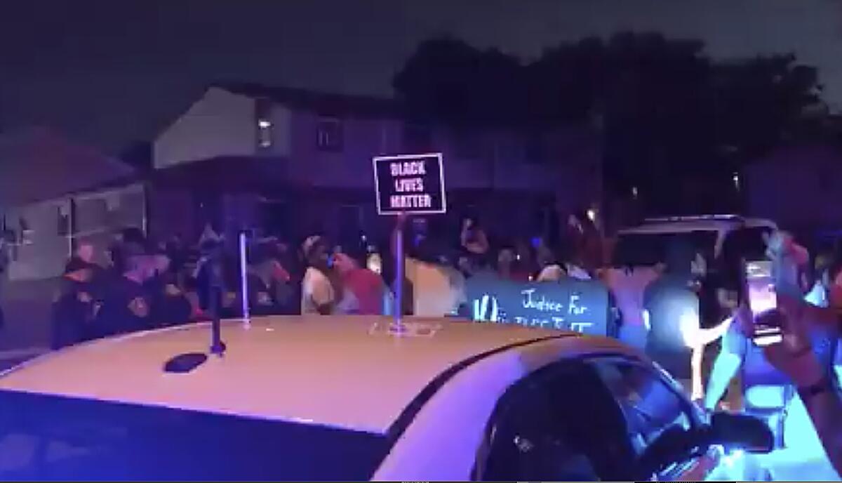 Protesters gather Sunday near the site of a police shooting in Kenosha, Wis.