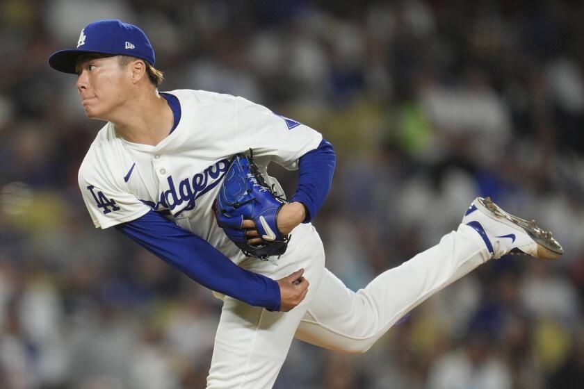 Los Angeles Dodgers pitcher Yoshinobu Yamamoto follows through on a pitch to a Miami Marlins batter during the fourth inning of a baseball game Tuesday, May 7, 2024, in Los Angeles. (AP Photo/Marcio Jose Sanchez)