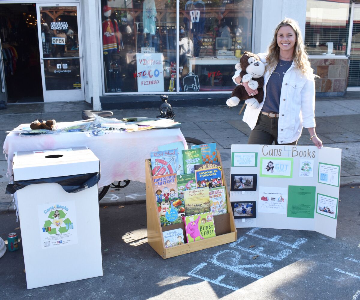 Trisha Goolsby set up a display at the CicloSDias Pacific Beach to share information for her Cans4Books Community Initiative.