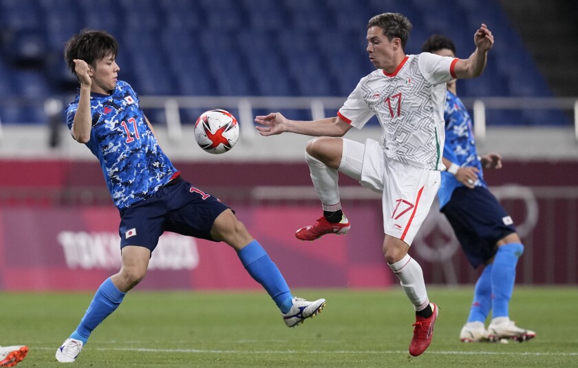 Mexico's Sebastian Cordova, right, and Japan's Ao Tanaka battle. (AP Photo/Martin Mejia)