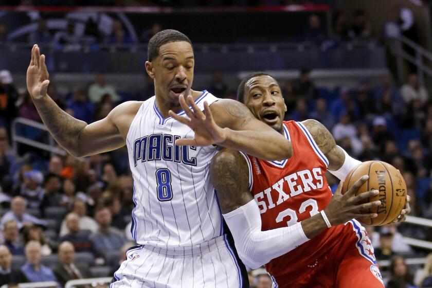 Magic forward Channing Frye (8) is called for a foul as he tries to block 76ers forward Robert Covington's (33) path to the basket.