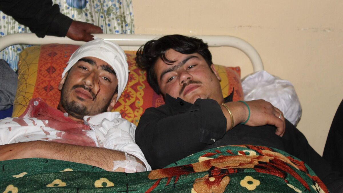 Two men injured in an explosion outside a Shiite mosque in Parachinar in northern Pakistan share a hospital bed on March 31, 2017.