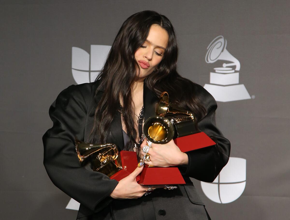 Rosalía with her three Latin Grammy Awards in the press room at MGM Grand Garden Arena in Las Vegas.