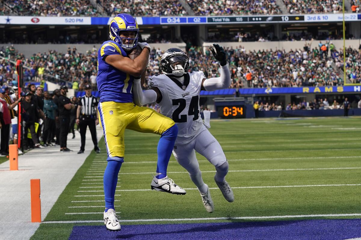 Rams receiver Puka Nacua catches a touchdown as Philadelphia Eagles cornerback James Bradberry defends.