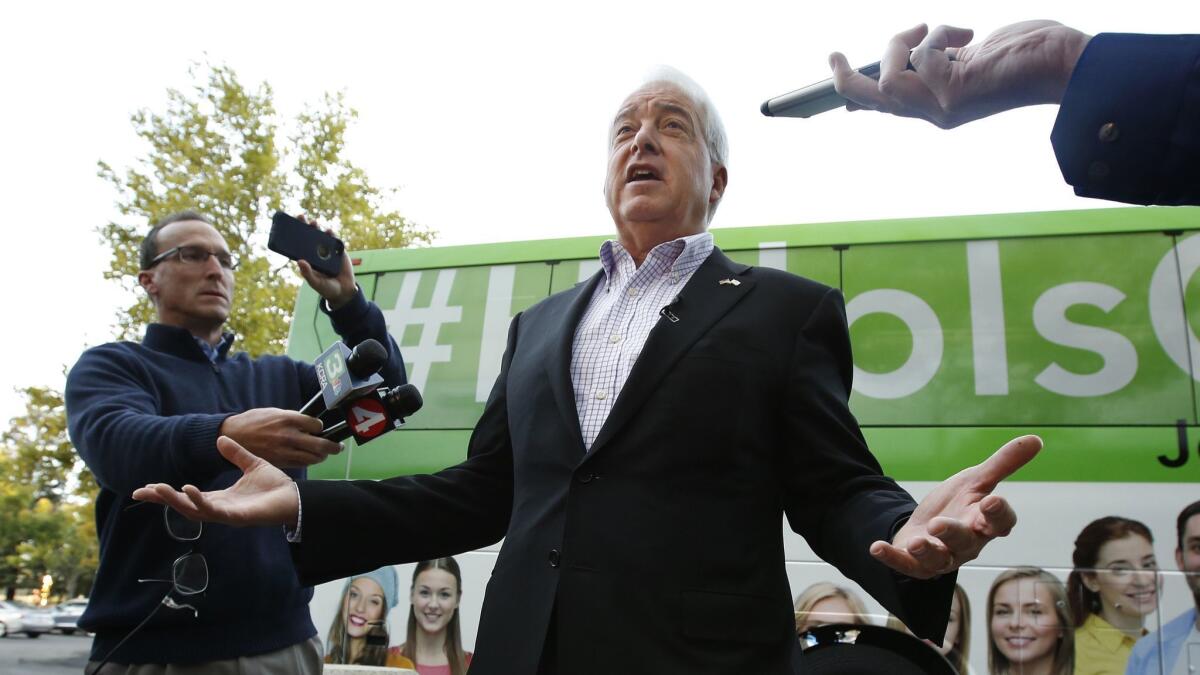Republican gubernatorial candidate John Cox talks to reporters before beginning a statewide bus tour Thursday, Nov. 1, in Sacramento. Cox is telling voters to ignore polls that show him well behind in the race.