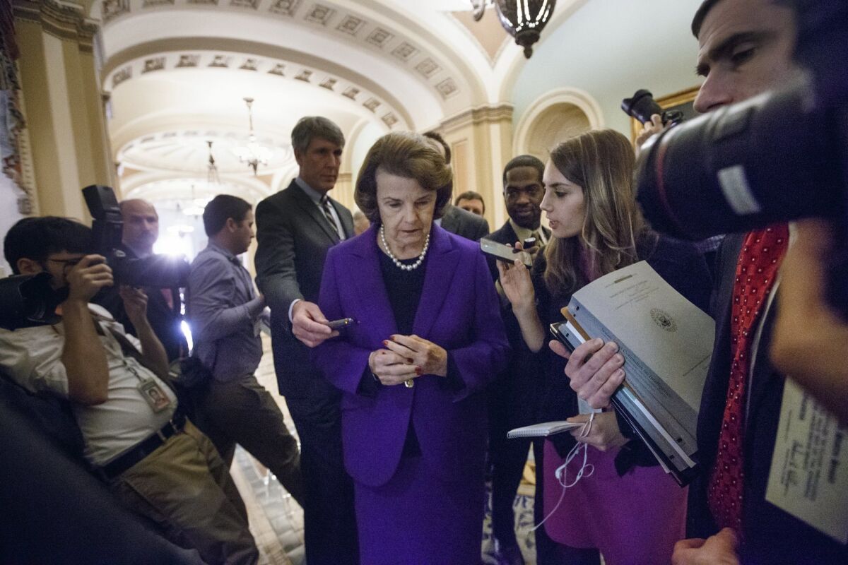 Senate Intelligence Committee Chair Sen. Dianne Feinstein, D-Calif. is surrounded by reporters on Capitol Hill in Washington, Tuesday, Dec. 9, 2014.
