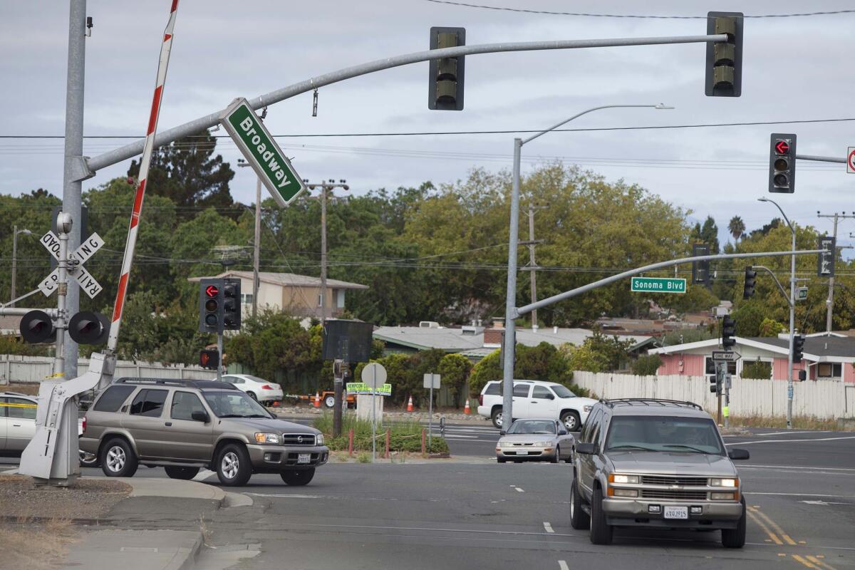 A street sign dangles over a busy street after the Napa earthquake on Sunday.