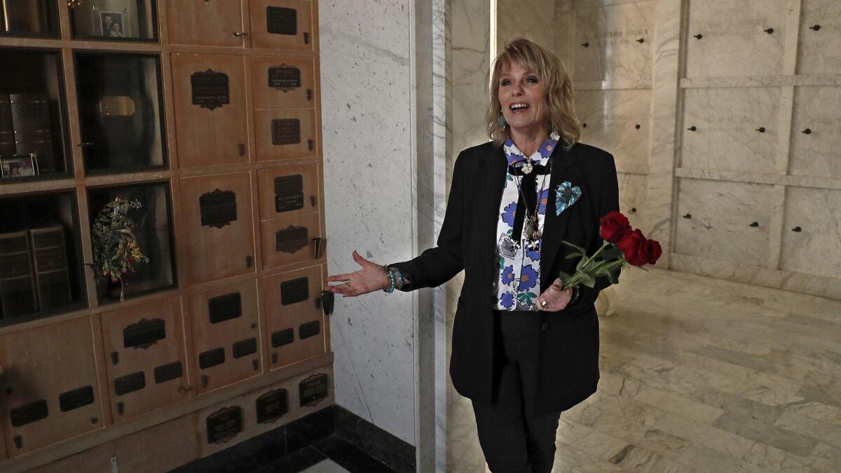 Jill Ann Lloyd, a funeral service director, stands beside her mother’s remains in the mausoleum at Fairhaven Memorial Park in Santa Ana. During Lloyd’s teenage years she went on a personal journey in search of her mother’s grave, which led her to the mausoleum at Fairhaven.