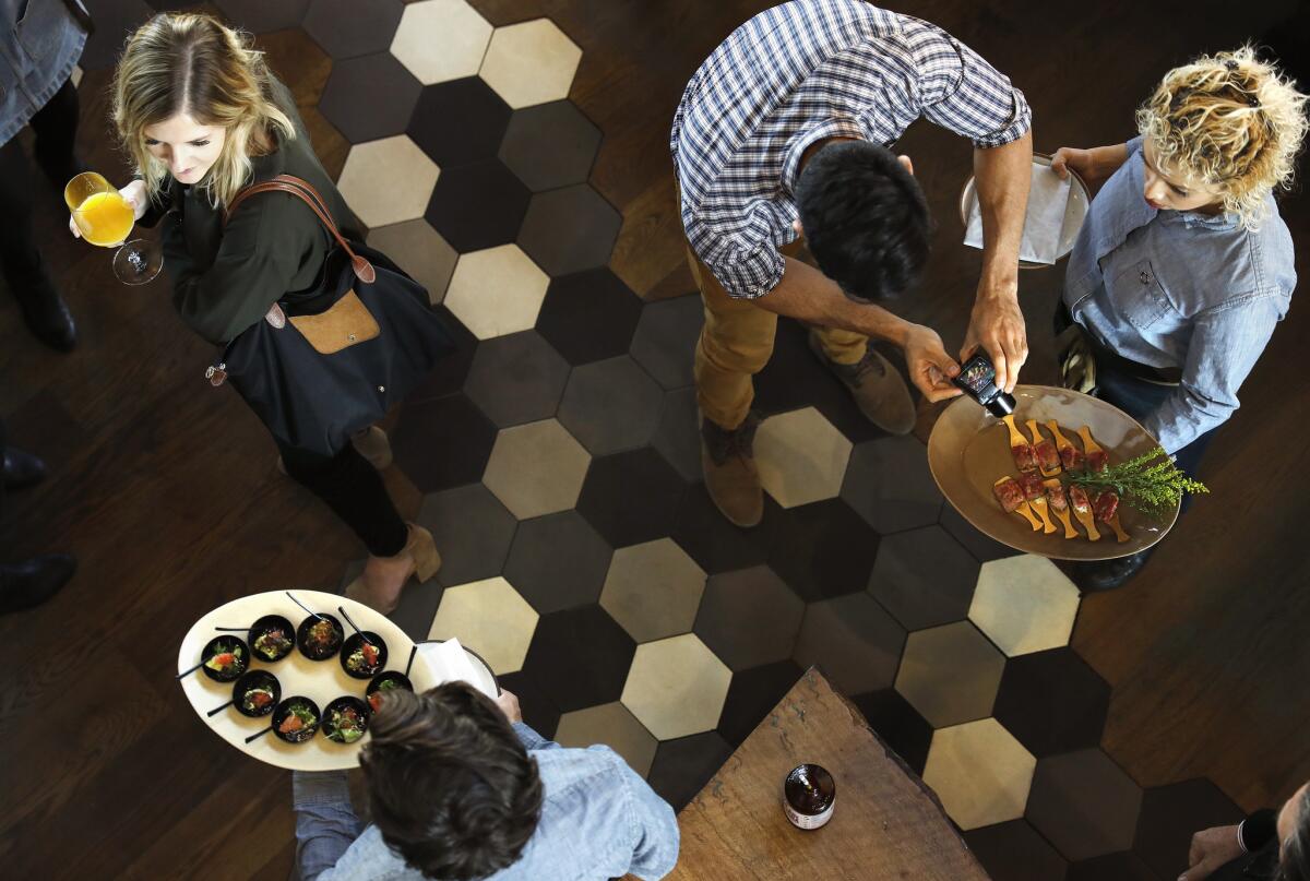Tray-passed food circulates the crowd at Otium in downtown Los Angeles.