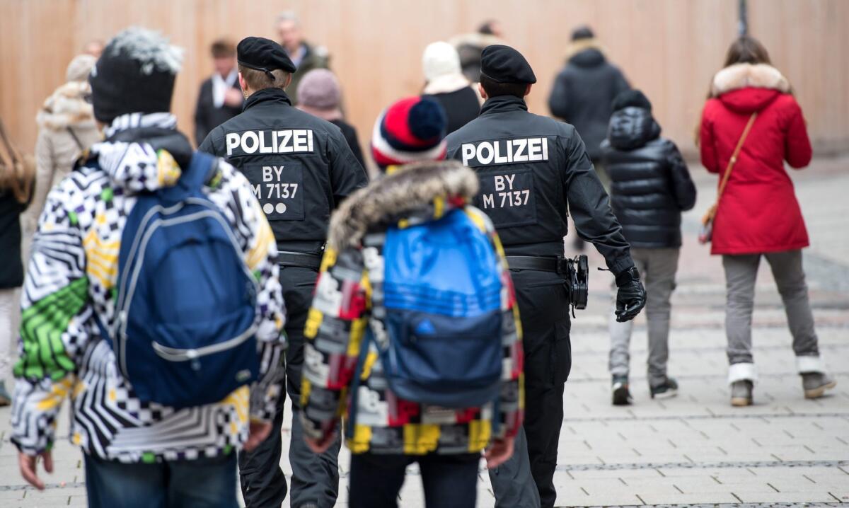 Members of the German police walk through Munich, Germany, on Friday.