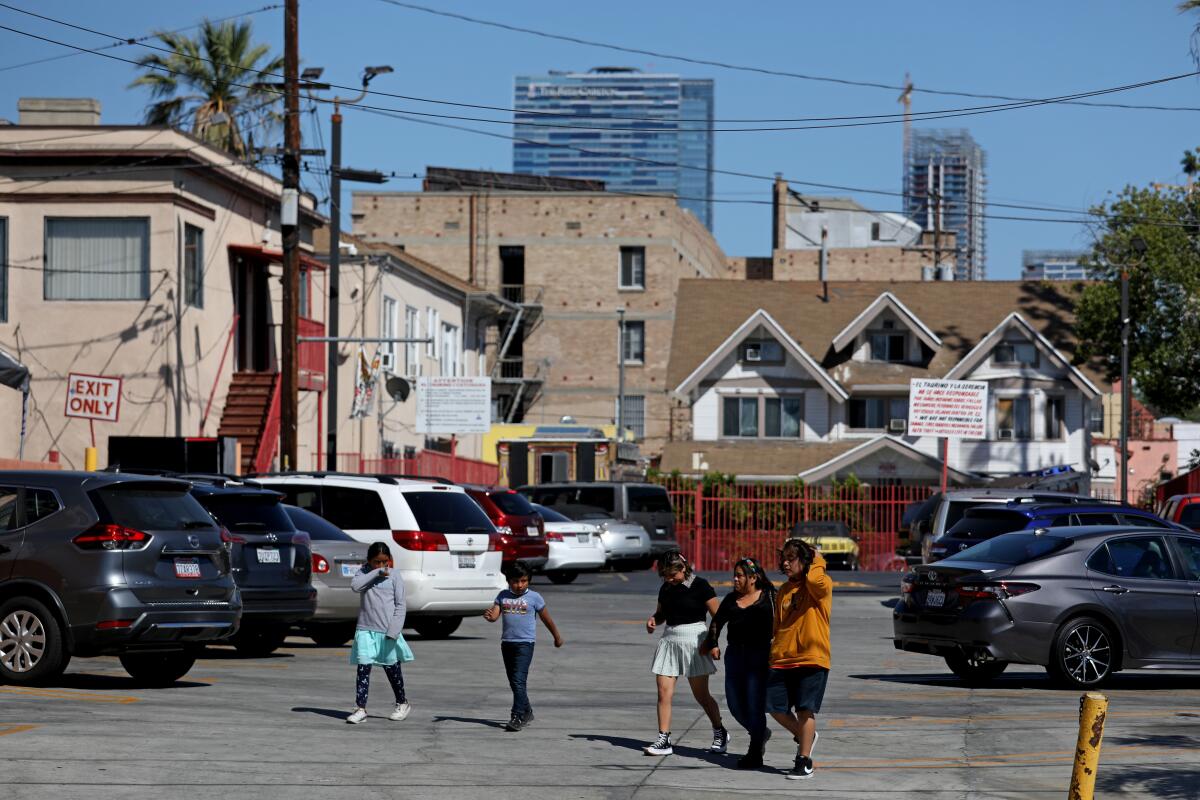 The Ritz-Carlton hotel and luxury condo high-rises in downtown L.A. loom over Pico-Union