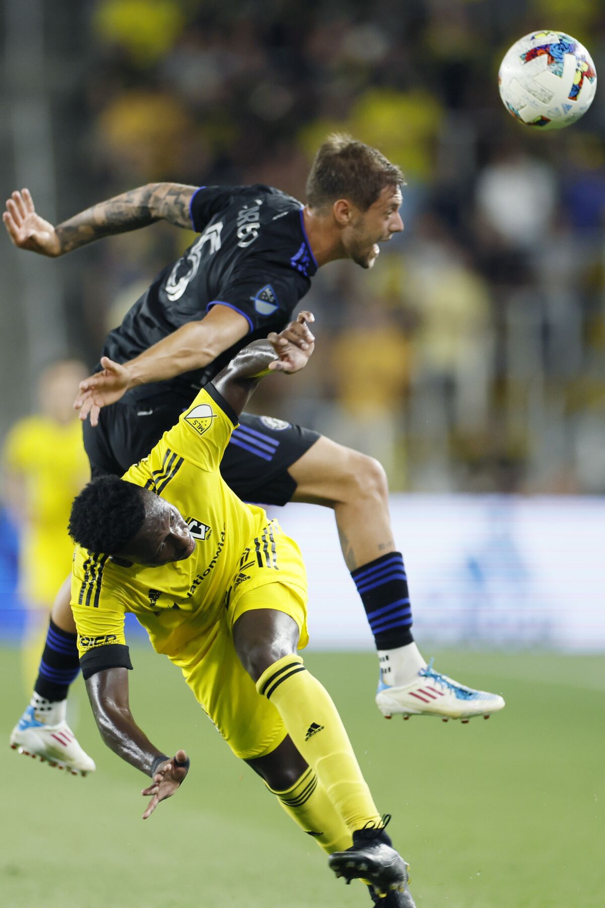 CF Montreal's Gabriele Corbo, top, heads the ball away from Columbus Crew's Derick Etienne during the second half of an MLS soccer match Wednesday, Aug. 3, 2022, in Columbus, Ohio. (AP Photo/Jay LaPrete)