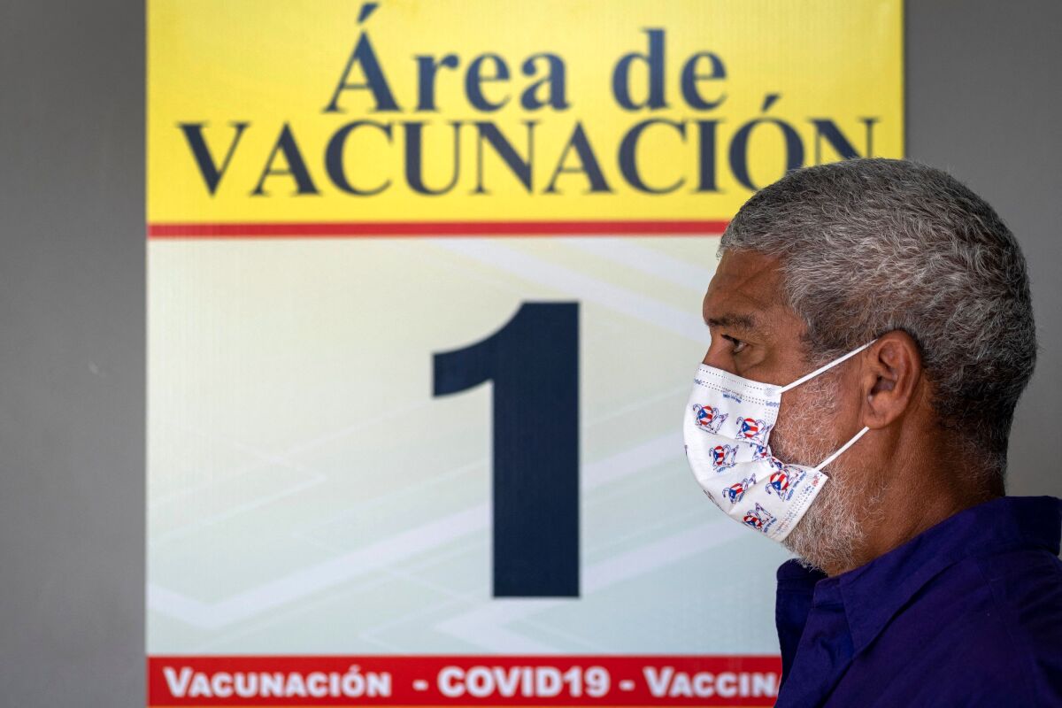 A man wearing a mask while in line for vaccination