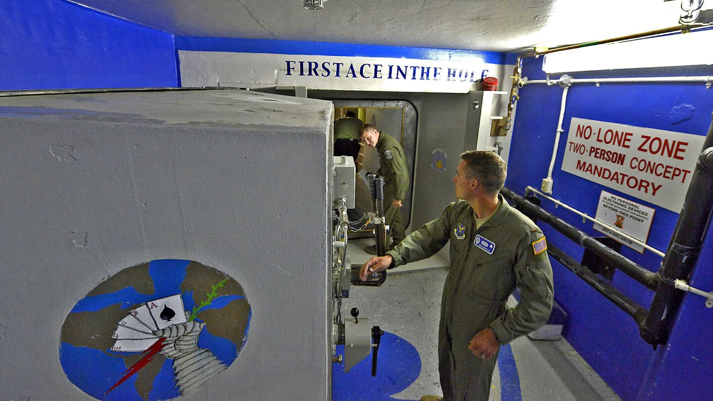 Griffith prepares to close a 3-foot-thick door at a launch control center concealed 70 feet below a small ranch house.
