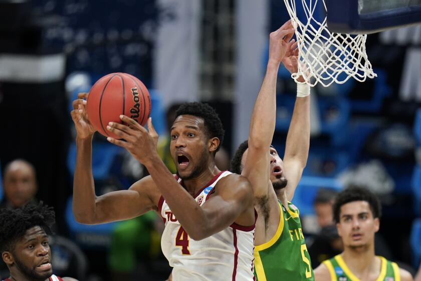 Southern California forward Evan Mobley (4) grabs a rebound in front of Oregon guard Chris Duarte (5) during the first half of a Sweet 16 game in the NCAA men's college basketball tournament at Bankers Life Fieldhouse, Sunday, March 28, 2021, in Indianapolis. (AP Photo/Jeff Roberson)