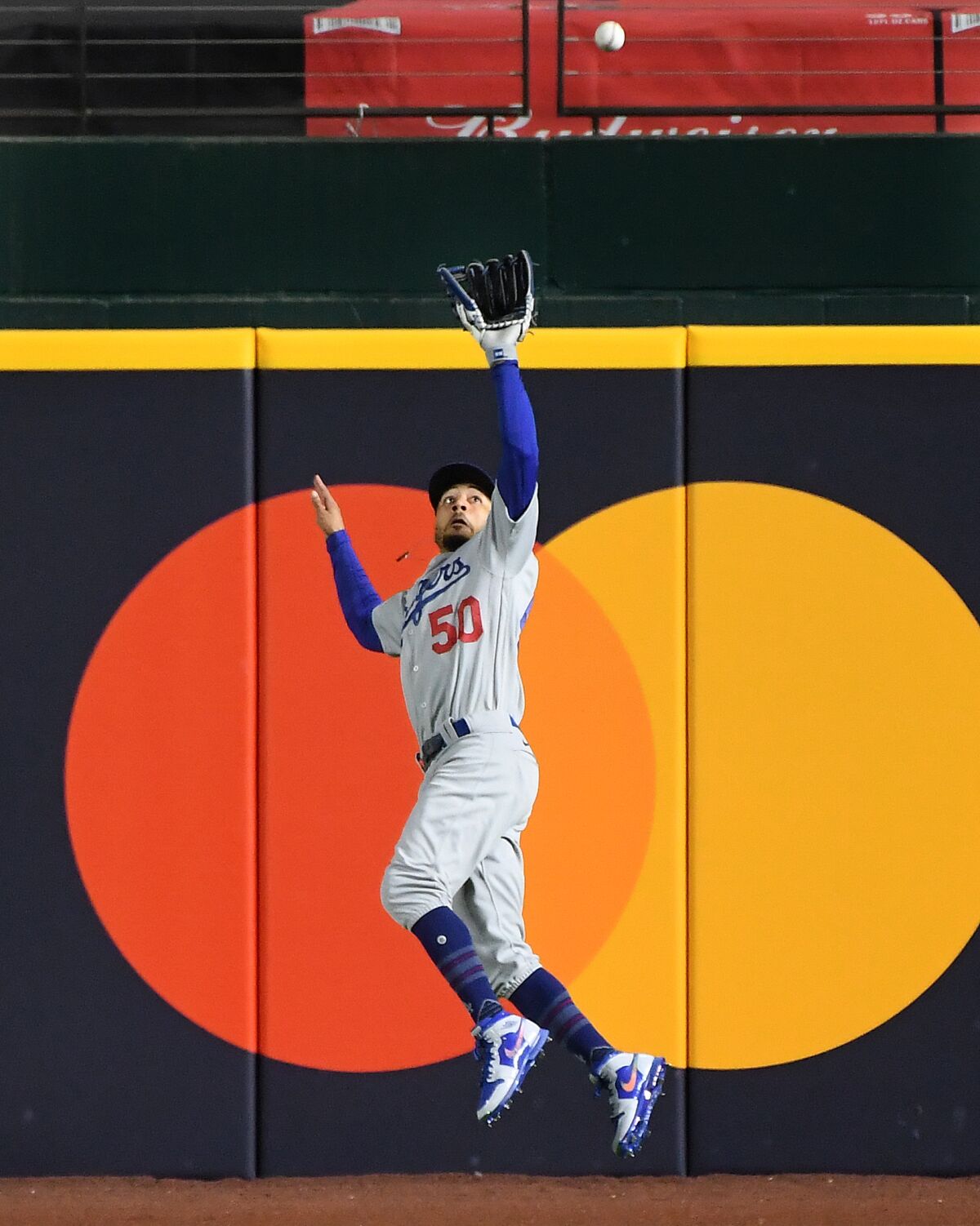 Dodgers right fielder Mookie Betts makes a leaping catch off the bat of Brandon Lowe during the second inning of Game 4.
