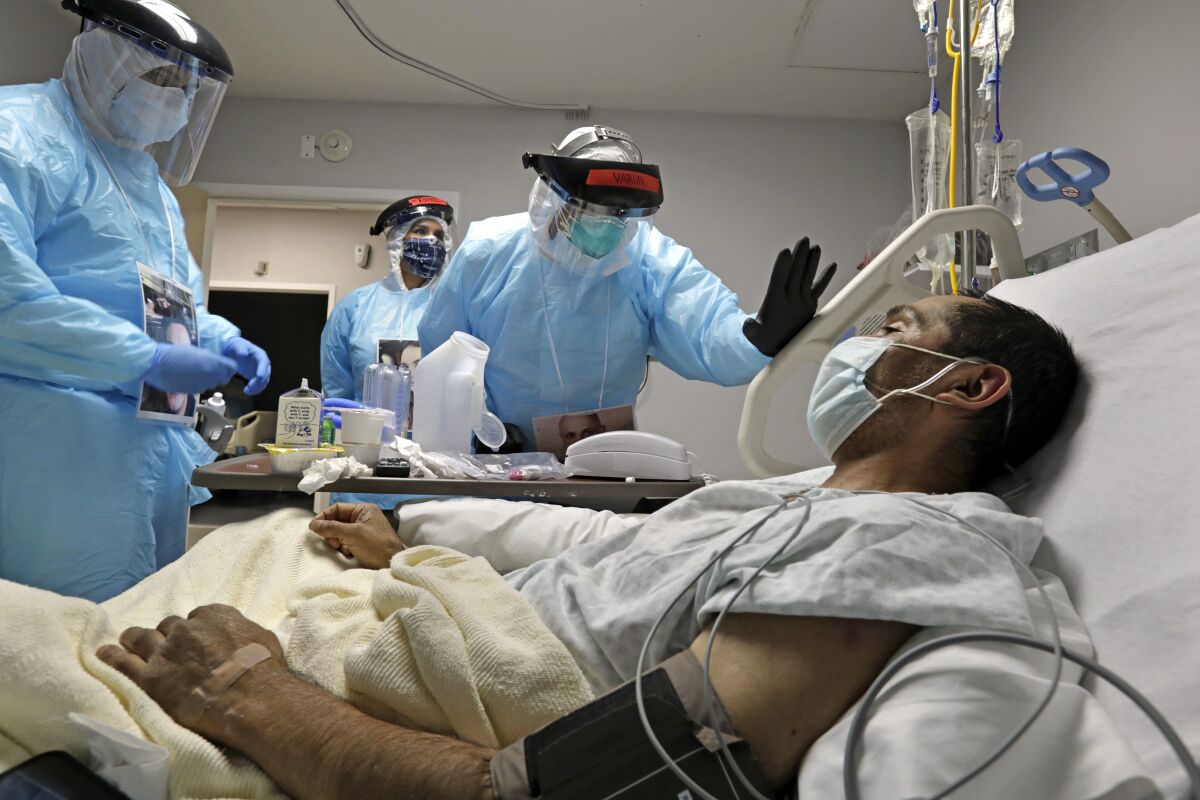 A doctor checks on a COVID patient