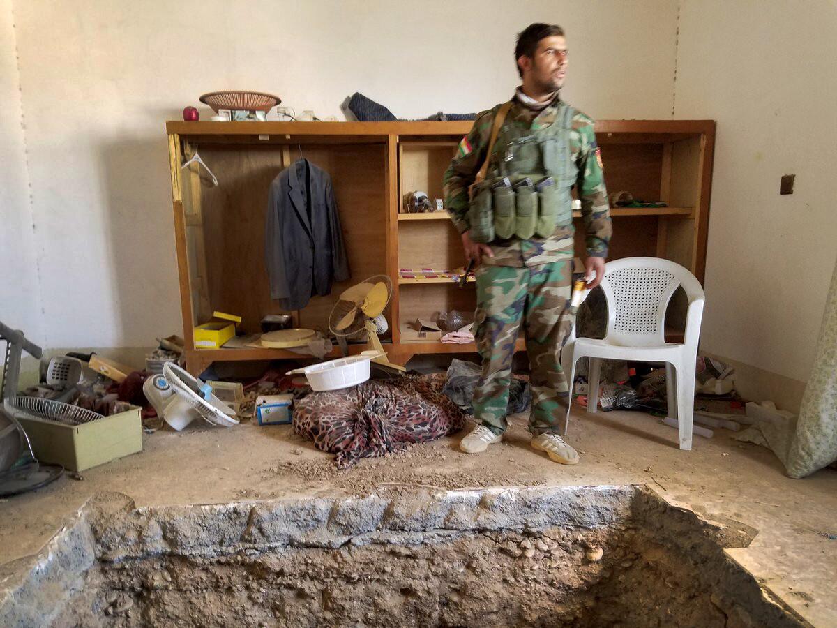 Ibrahim Hussein, 23, a peshmerga fighter, stands near a tunnel leading to the underground hide-out of an Islamic State leader reportedly killed in Shakoli, Iraq, during this week’s Mosul offensive.
