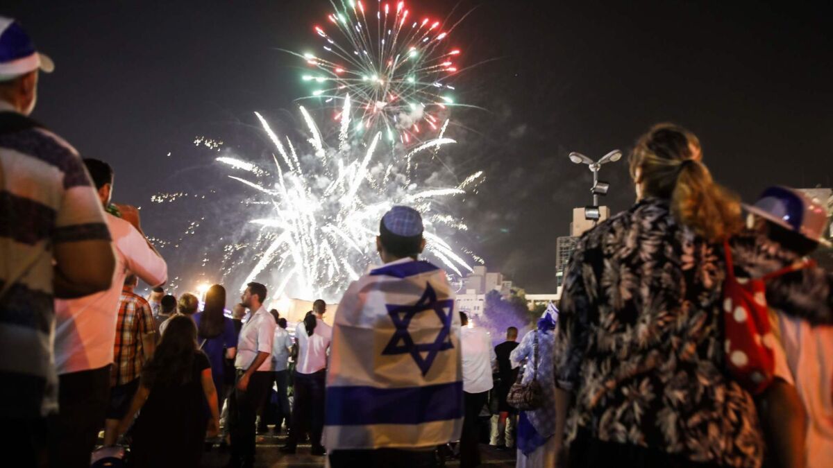 Israeli youths watch fireworks over the center of Jerusalem as Independence Day celebrations start.
