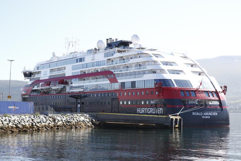 Norwegian cruise ship MS Roald Amundsen moored in Tromso, Norway, Monday Aug. 3, 2020. After 40 people, including four passengers and 26 crew members on the Norwegian cruise ship have been tested positive for the coronavirus, the operator says it was stopping for all cruises with its three vessels. The 40 people were admitted to the University Hospital of North Norway in Tromsoe, north of the Arctic Circle, where the empty ship has docked. (Terje Pedersen/NTB Scanpix via AP)