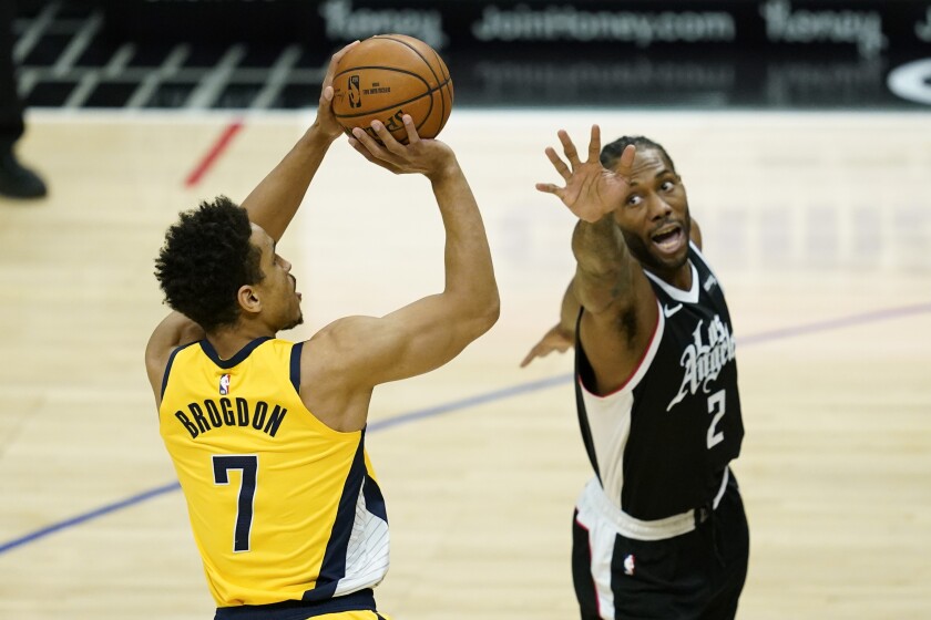 Indiana Pacers guard Malcolm Brogdon (7) shoots against Los Angeles Clippers forward Kawhi Leonard (2) during the first quarter of an NBA basketball game, Sunday, Jan. 17, 2021, in Los Angeles. (AP Photo/Ashley Landis)