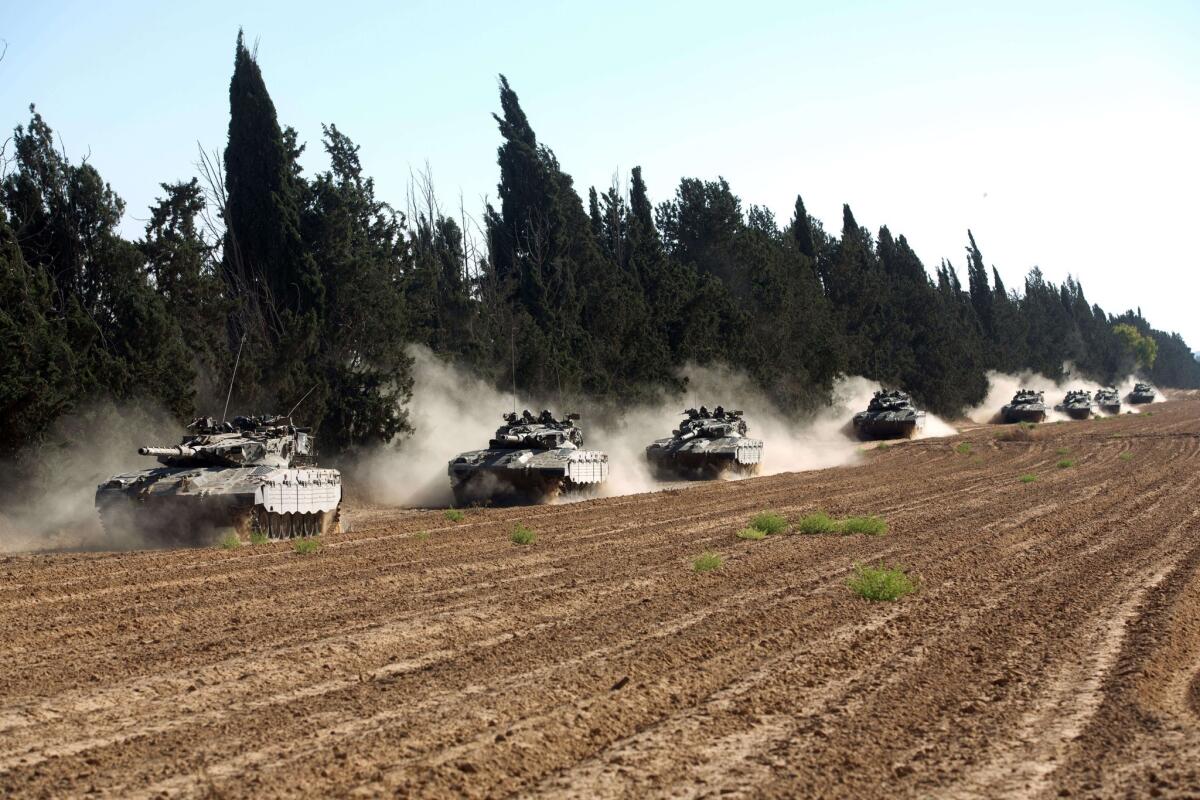 A convoy of Israeli Merkava tanks roll near Israel's border.