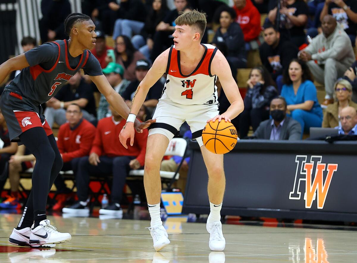 Nikolas Khamenia of Harvard-Westlake dribbles the ball while guarded by an opponent.