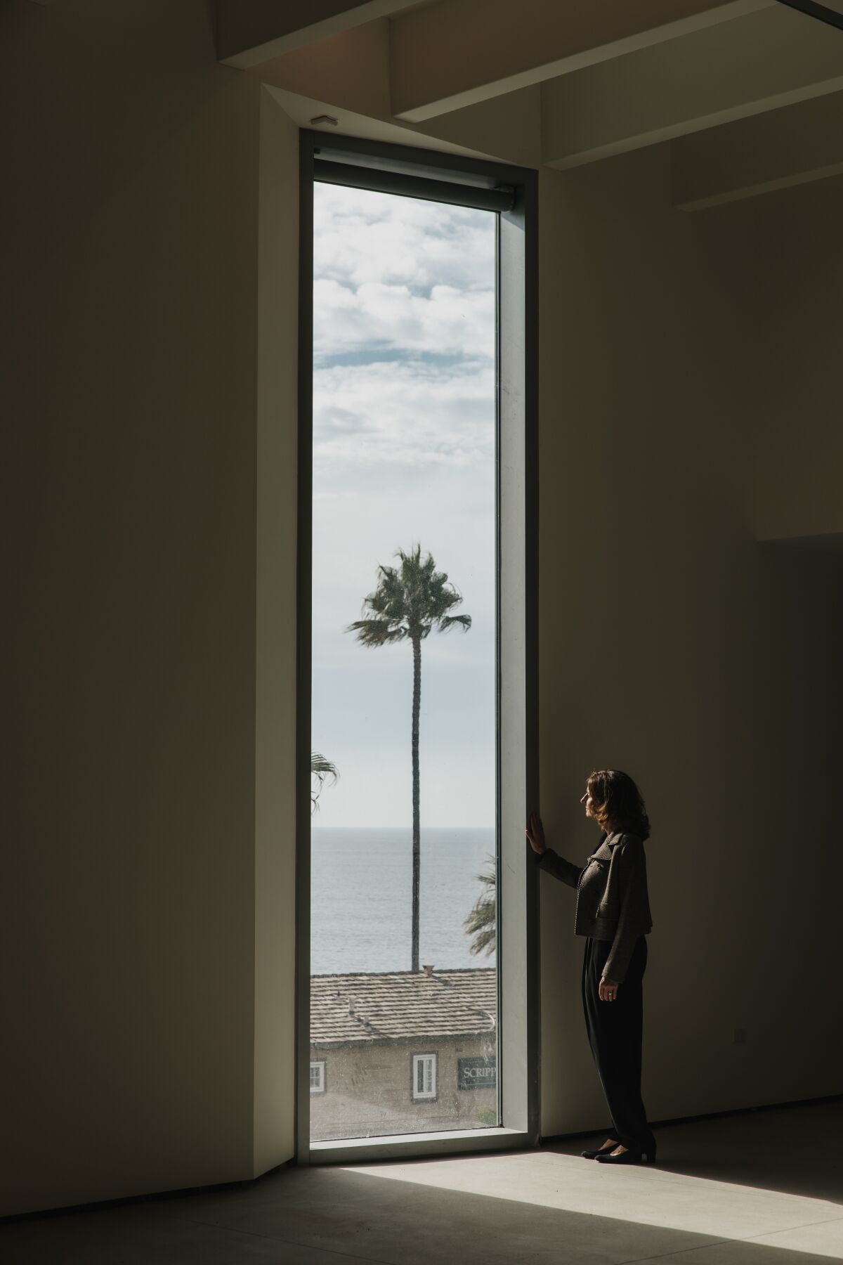 MCASD Chief Executive Kathryn Kanjo looks out over Cuvier Street from one of the La Jolla museum's new windows.