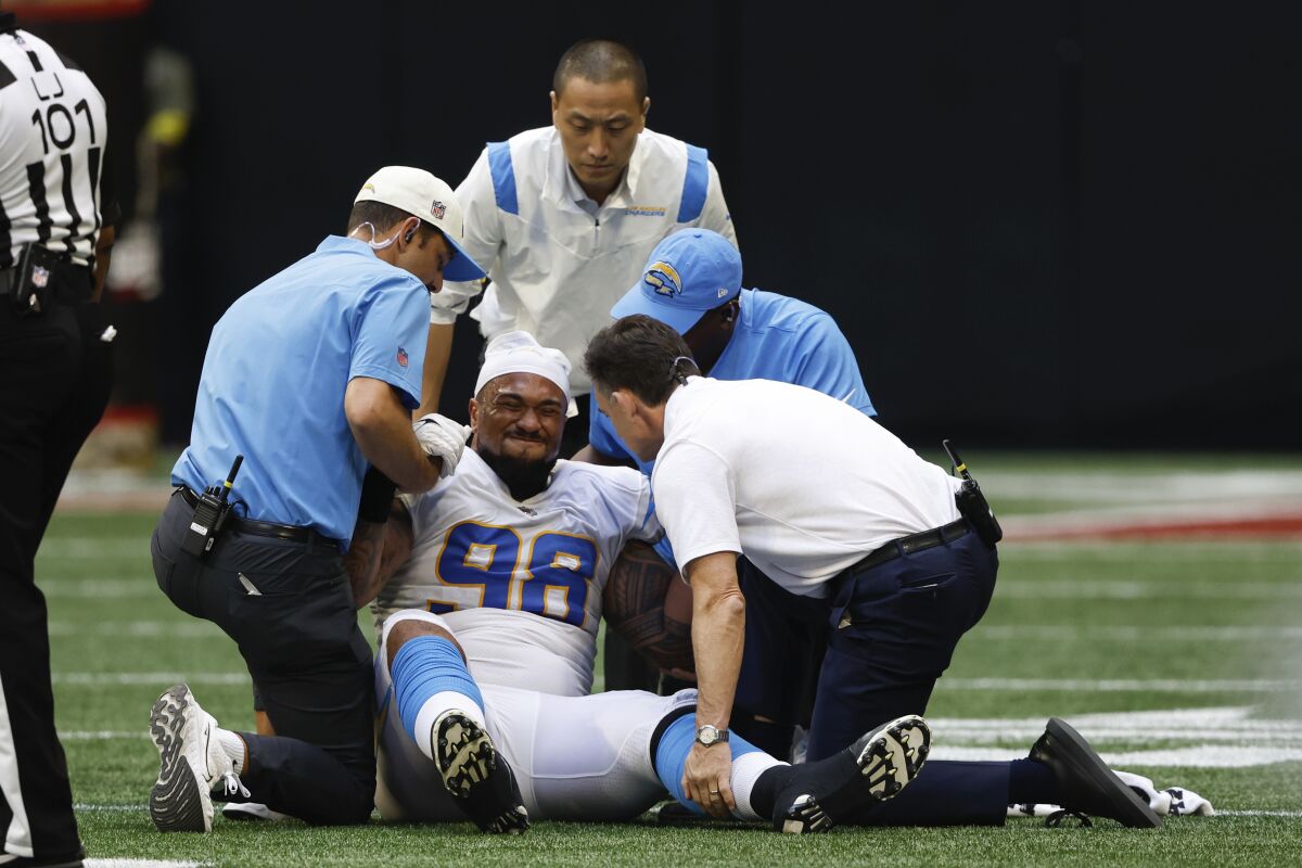 Chargers defensive tackle Austin Johnson (98) is helped out of the field after being injured against the Atlanta Falcons.