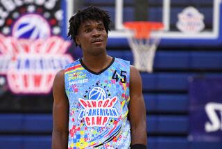 Tounde Yessoufou stands on the court and looks up during the Pangos All-American Camp in Las Vegas