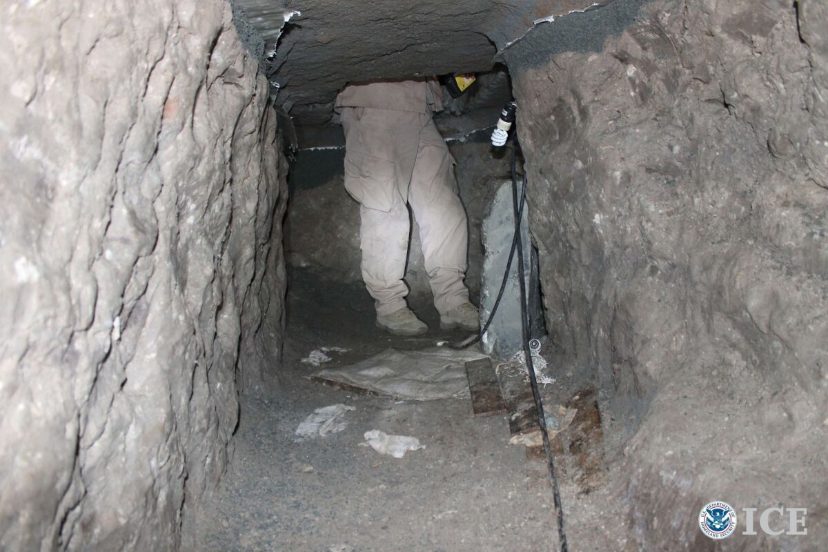 A U.S. Immigration and Customs Enforcement (ICE) officer stands at the exit of a suspected drug smuggling tunnel in Otay Mesa, south of San Diego, California.