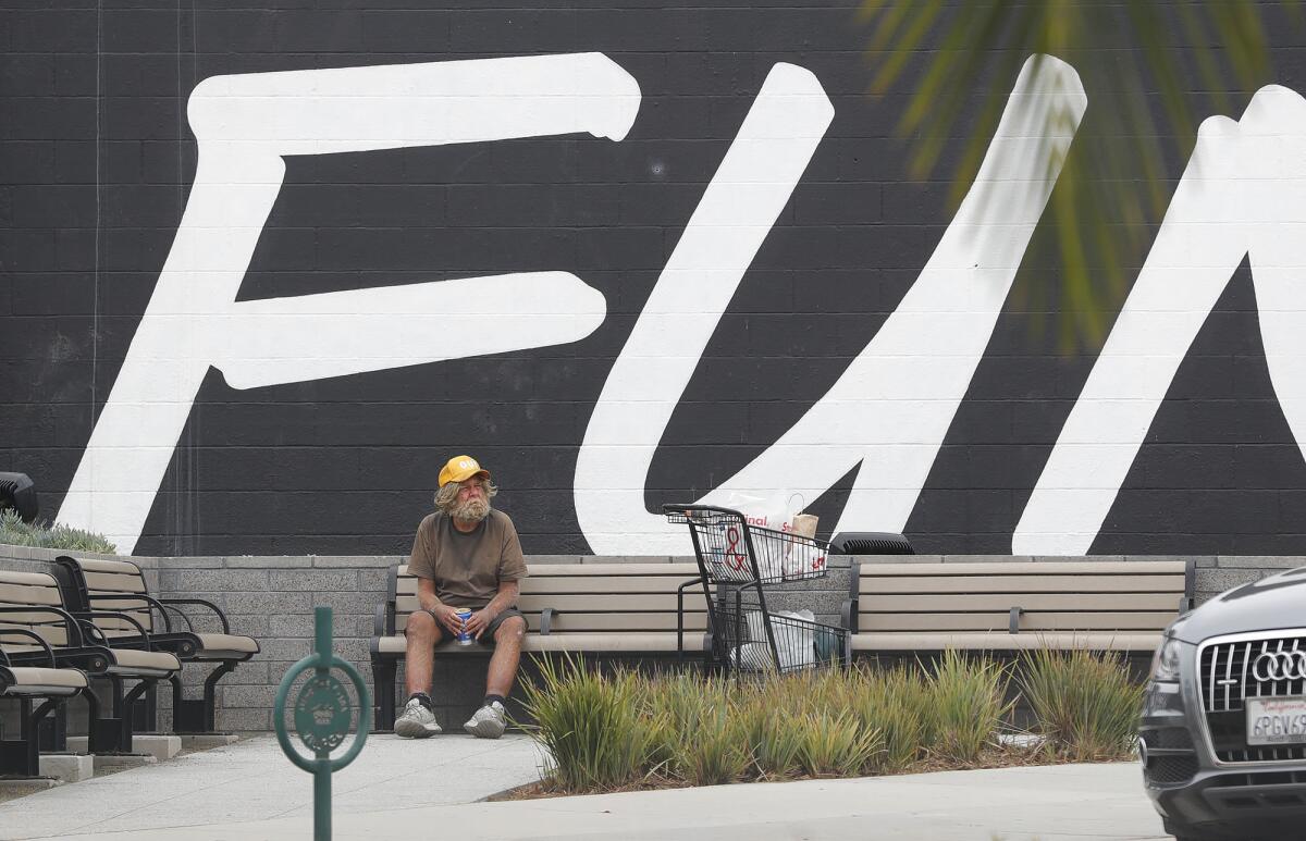A man sits on a bench in Corona del Mar.