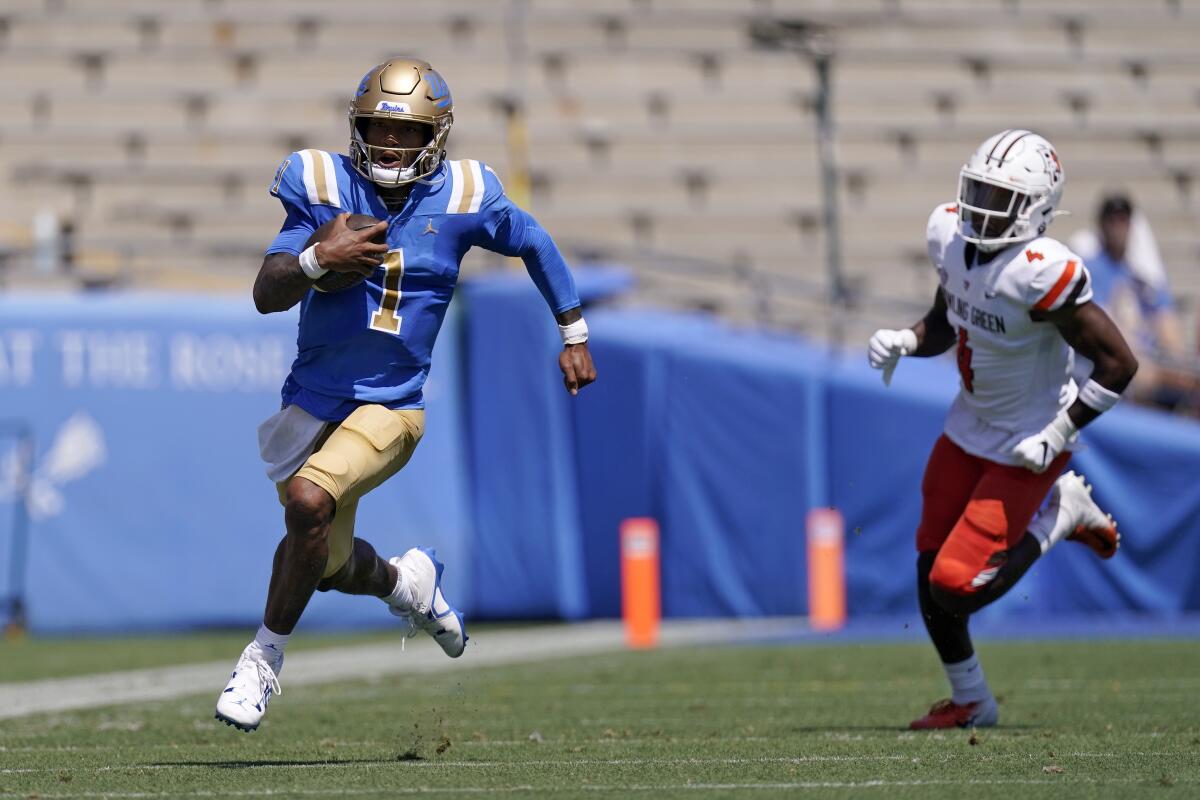UCLA quarterback Dorian Thompson-Robinson, left, runs for a touchdown as Bowling Green cornerback Deshawn Jones Jr. gives chase during the first half of an NCAA college football game Saturday, Sept. 3, 2022, in Pasadena, Calif. (AP Photo/Mark J. Terrill)