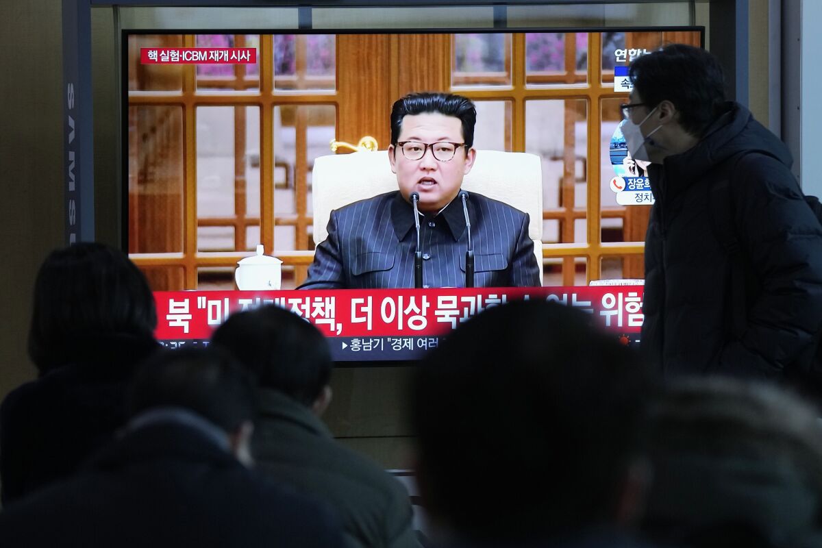 People watch a TV showing a file image of North Korean leader Kim Jong Un shown during a news program at the Seoul Railway Station in Seoul, South Korea, Thursday, Jan. 20, 2022. Accusing the United States of hostility and threats, North Korea on Thursday said it will consider restarting "all temporally-suspended activities" it had paused during its diplomacy with the Trump administration, in an apparent threat to resume testing of nuclear explosives and long-range missiles. (AP Photo/Ahn Young-joon)