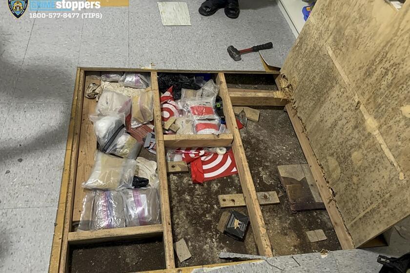 FILE - In this photo provided by the New York City Police Department, a trap door leans open over narcotics, including fentanyl, and drug paraphernalia stored in the floor of a day care center, Sept. 21, 2023, in New York. Two men connected to a toddler’s fatal opioid overdose at the New York City daycare have pleaded guilty to drug charges and causing bodily harm, prosecutors said Monday, June 10, 2024. (Courtesy NYPD via AP, File)