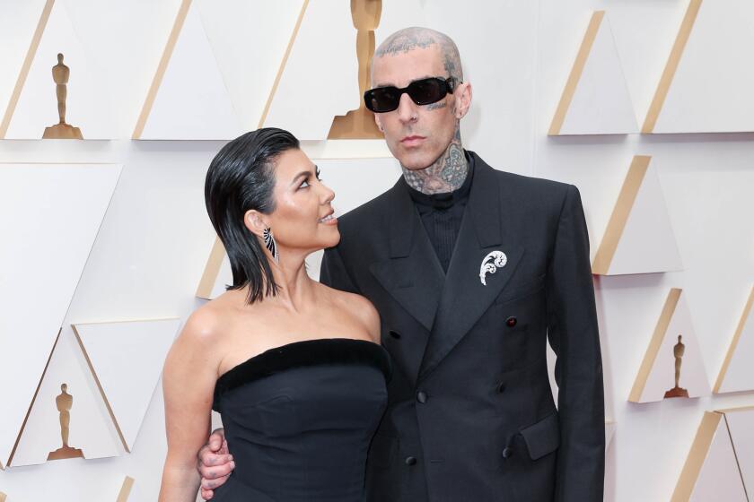 Kourtney Kardashian and Travis Barker attend the 94th Annual Academy Awards at Hollywood and Highland 