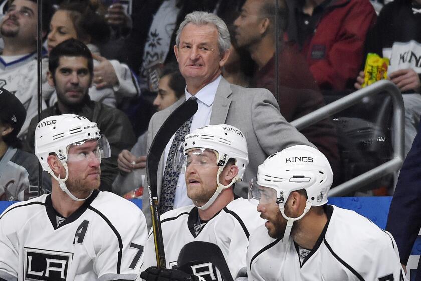 Kings Coach Darryl Sutter stands behind his bench during a game against Anaheim on Feb. 4.