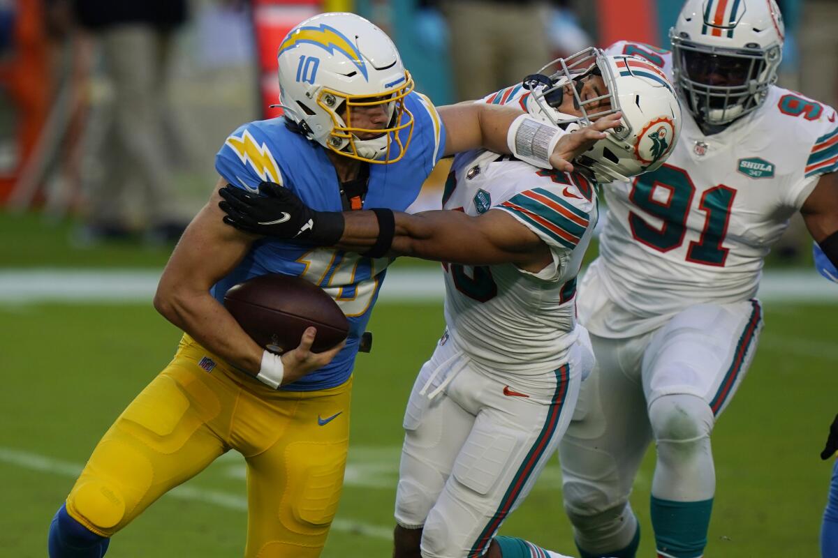 Miami Dolphins defensive back Nik Needham sacks Chargers quarterback Justin Herbert.