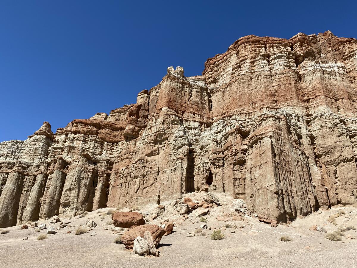 Sculpted cliffs under clear blue skies.