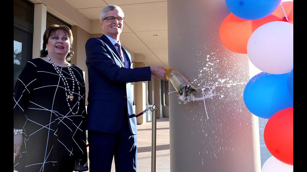 The new Sierra Vista building at Glendale Community College was launched with a bottle of champagne by board of education president Dr. Armine Hacopian, left, and GCC president Dr. David Viar, during ceremony on campus in Glendale on Thursday, Feb. 15, 2018. The three-story building houses office like admissions and records, counseling, career services, financial aid, as well as classrooms, the journalism department and the culinary school.