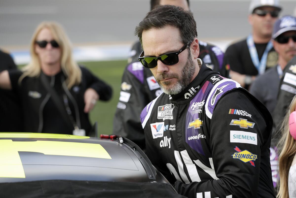 In this Feb. 16, 2020, photo, Jimmie Johnson climbs into his car before the Daytona 500.