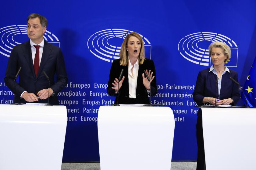 From left, Belgium's Prime Minister Alexander De Croo, European Parliament President Roberta Metsola and European Commission President Ursula von der Leyen participate in a media conference at the European Parliament in Brussels, Wednesday, April 10, 2024. Lawmakers are voting Wednesday on a major revamp of the European Union's migration laws aiming to end years of division over how to manage the entry of thousands of people without authorization and deprive the far-right of a vote-winning campaign issue ahead of June elections. (AP Photo/Geert Vanden Wijngaert)