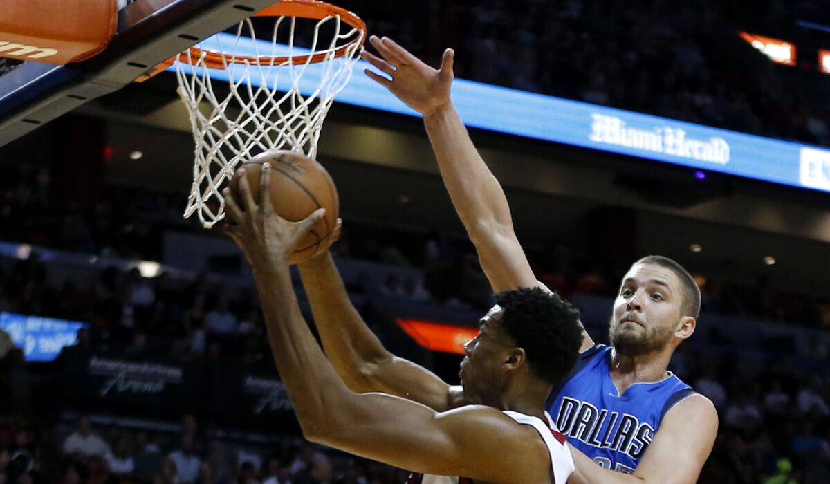 Miami Heat center Hassan Whiteside (21) shoots as Dallas Mavericks forward Chandler Parsons (25) defends in the second half on Jan. 1.