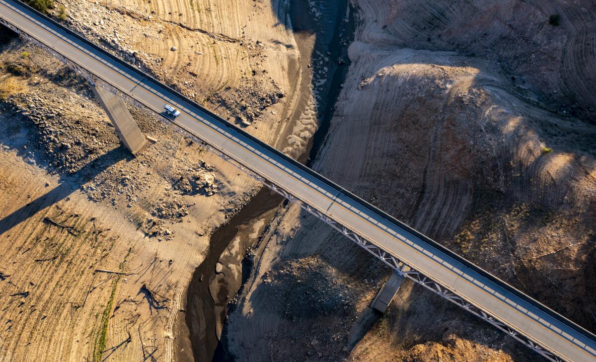 A truck crosses the Enterprise Bridge at Lake Oroville, which is 33% full
