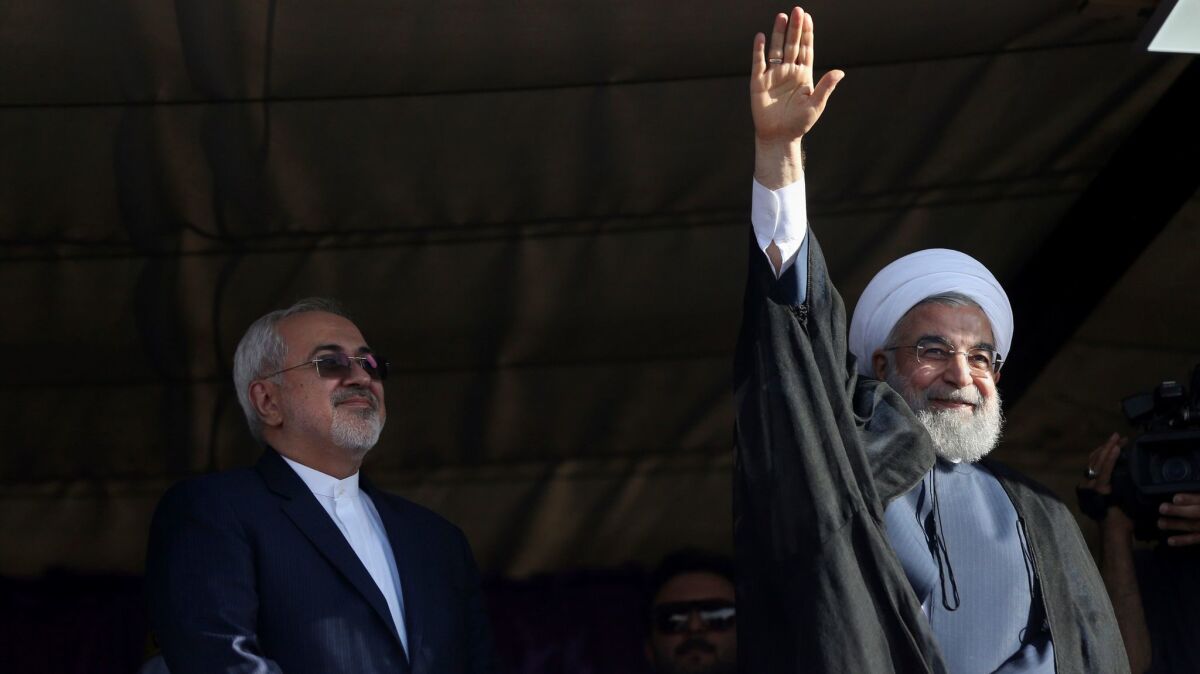 Iranian President Hassan Rouhani, right, accompanied by Foreign Minister Mohammad Javad Zarif, waves to his supporters during a May 14 campaign rally in the city of Isfahan.