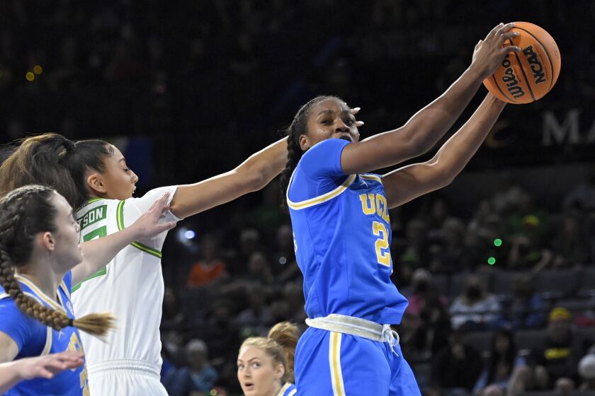 UCLA guard Charisma Osborne (20) rebounds the ball against Oregon during an NCAA college basketball game in the quarterfinals of the Pac-12 women's tournament Thursday, March 3, 2022, in Las Vegas. (AP Photo/David Becker)