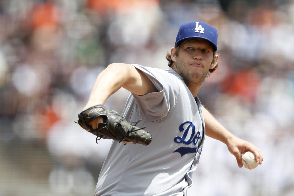 Dodgers pitcher Clayton Kershaw throws during the first inning against the Giants. Kershaw allowed four runs in 7 1/3 innings.