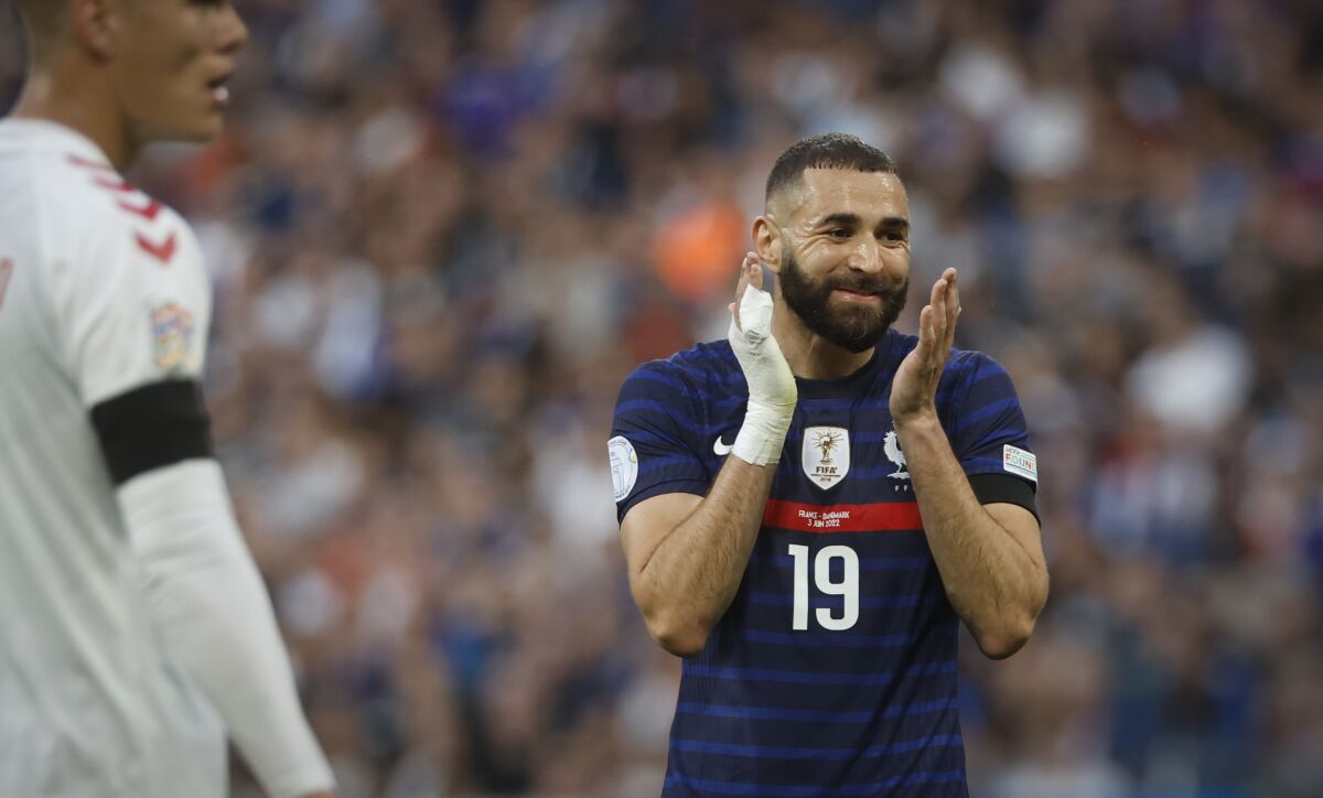 France's Karim Benzema, right, reacts during the UEFA Nations League soccer match between France and Denmark at the Stade de France in Saint Denis near Paris, France, Friday, June 3, 2022. (AP Photo/Jean-Francois Badias)